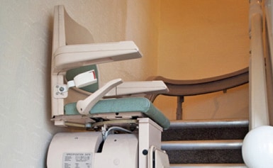 Stair lift at the foot of the stairs